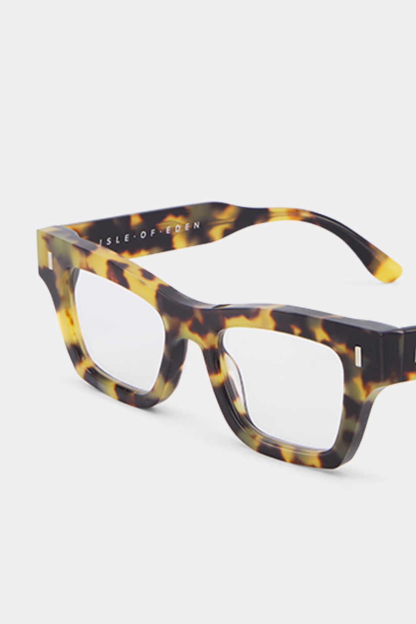 Isle of Eden Olli prescription glasses, angled side view showing the eco-conscious tortoiseshell bio-acetate frame with brand lettering detail