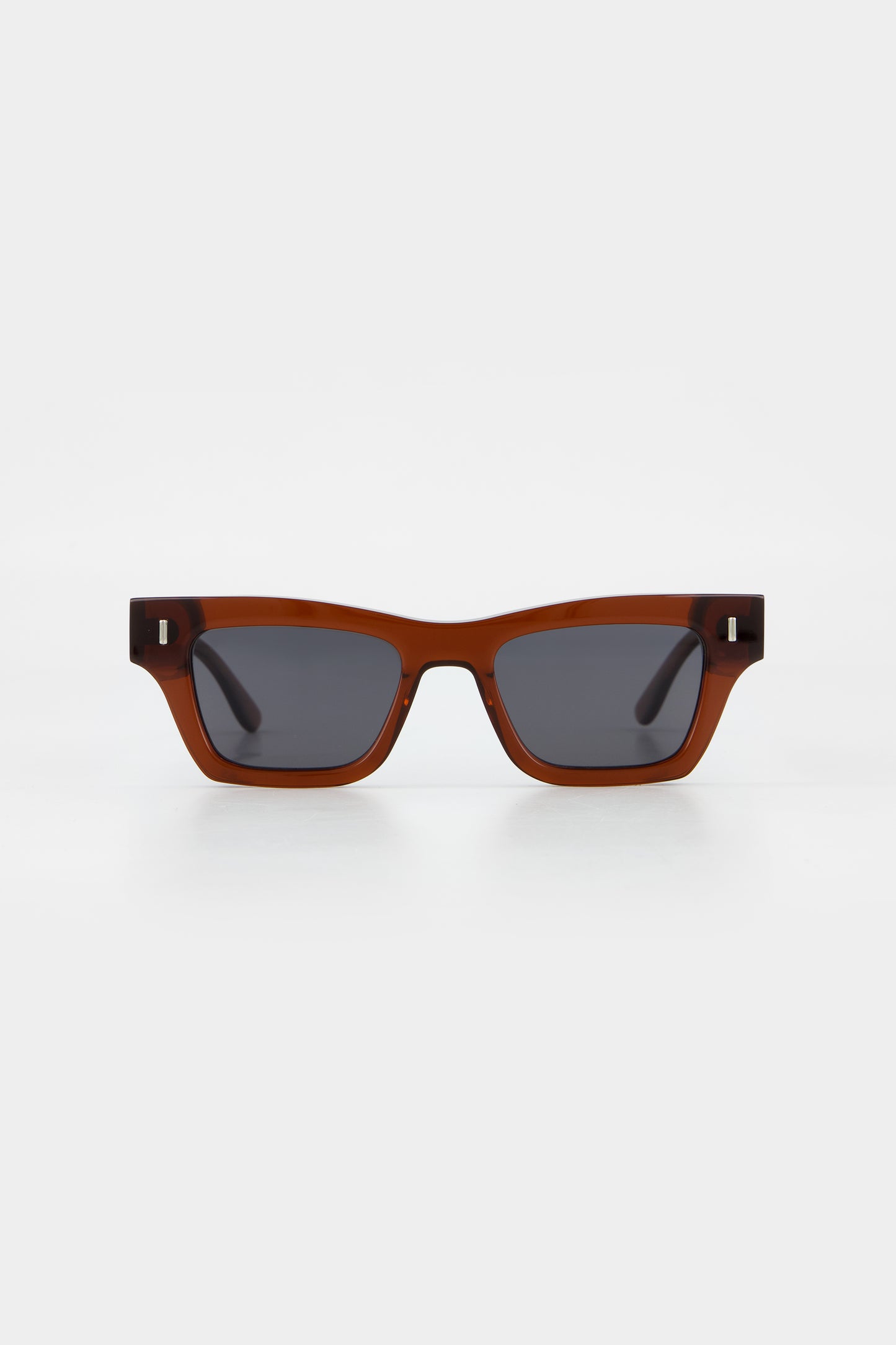 Isle of Eden Olli brown sunglasses, front view showing low-profile art-deco frame and dark lenses