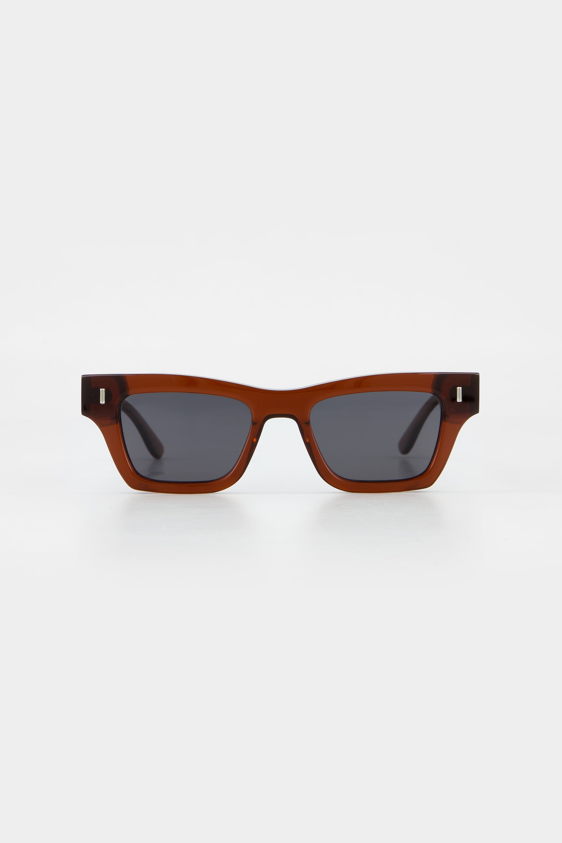 Isle of Eden Olli brown sunglasses, front view showing low-profile art-deco frame and dark lenses