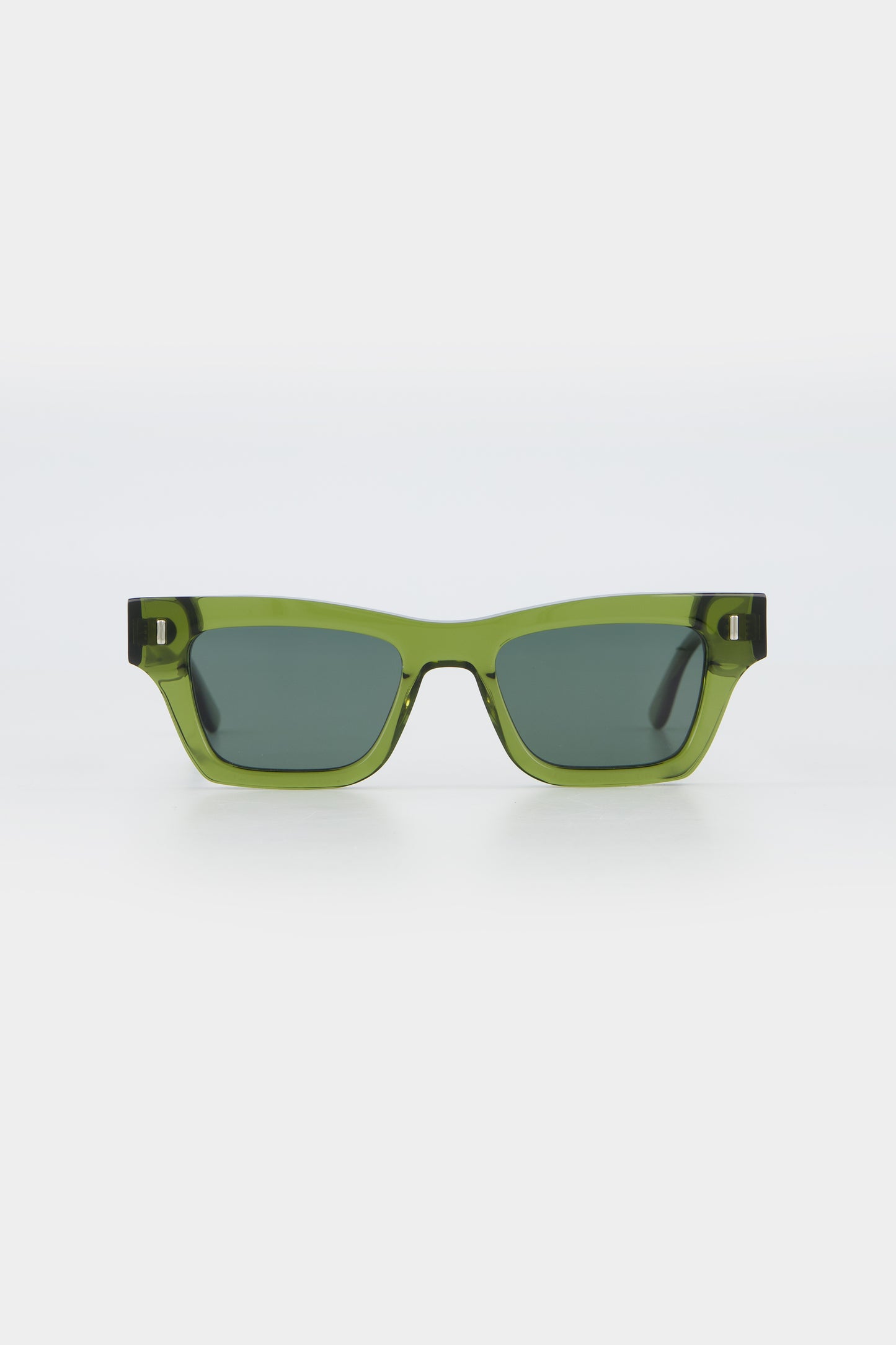 Isle of Eden Olli bottle green sunglasses, front view showing low-profile art-deco frame and dark green lenses