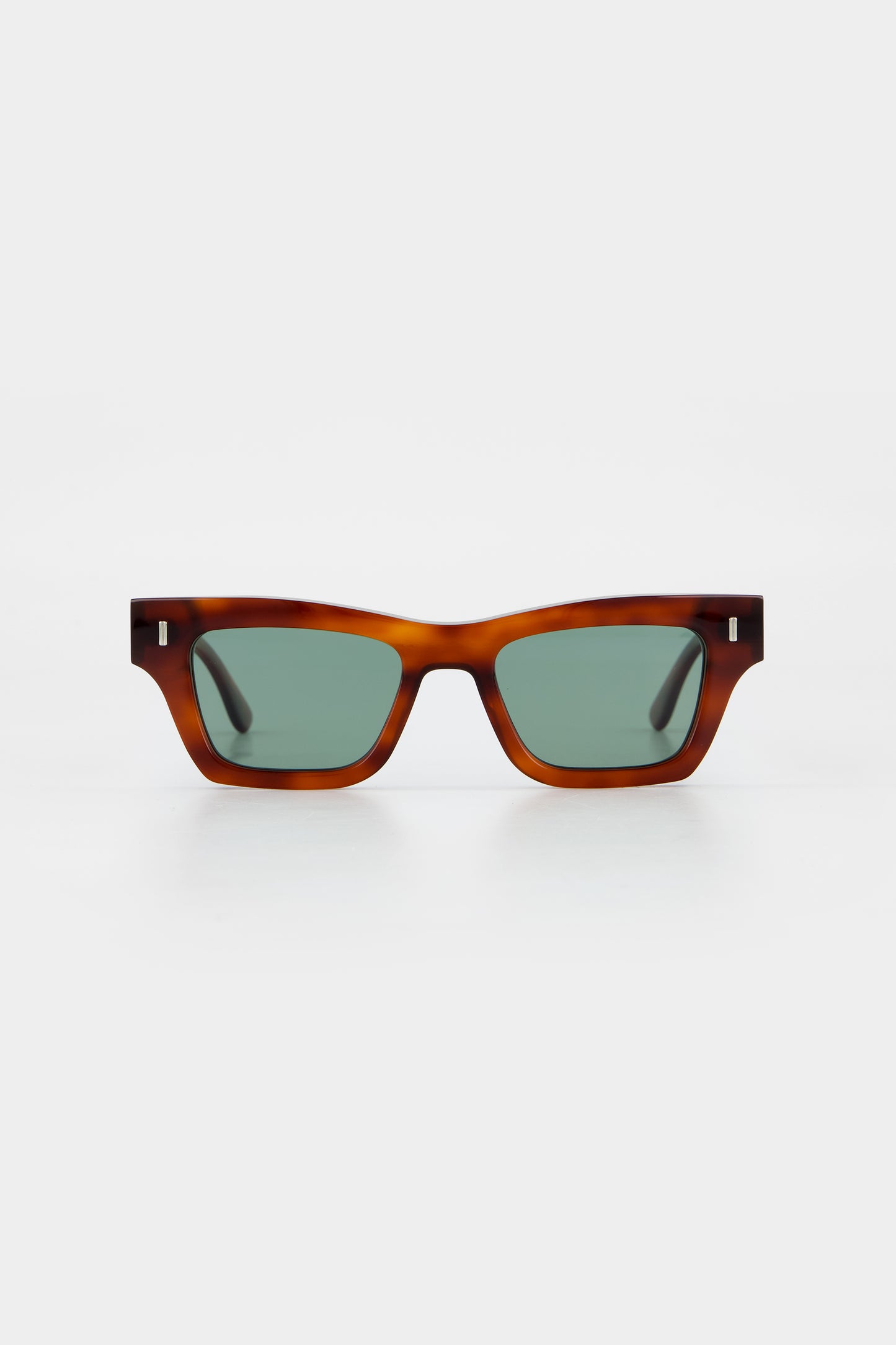 Isle of Eden Olli honey tortoise sunglasses, front view showing low-profile art-deco frame and green lenses
