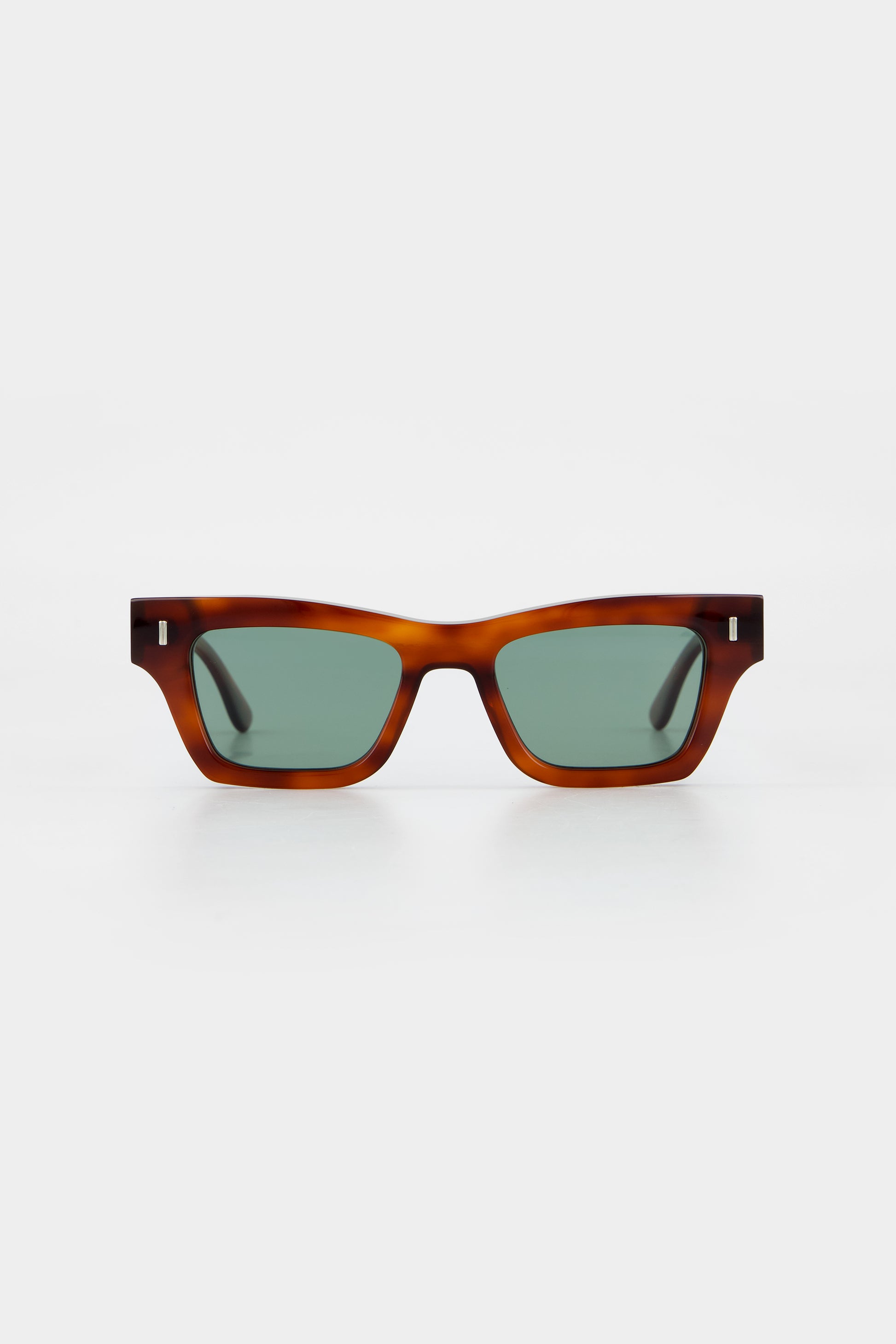 Isle of Eden Olli honey tortoise sunglasses, front view showing low-profile art-deco frame and green lenses
