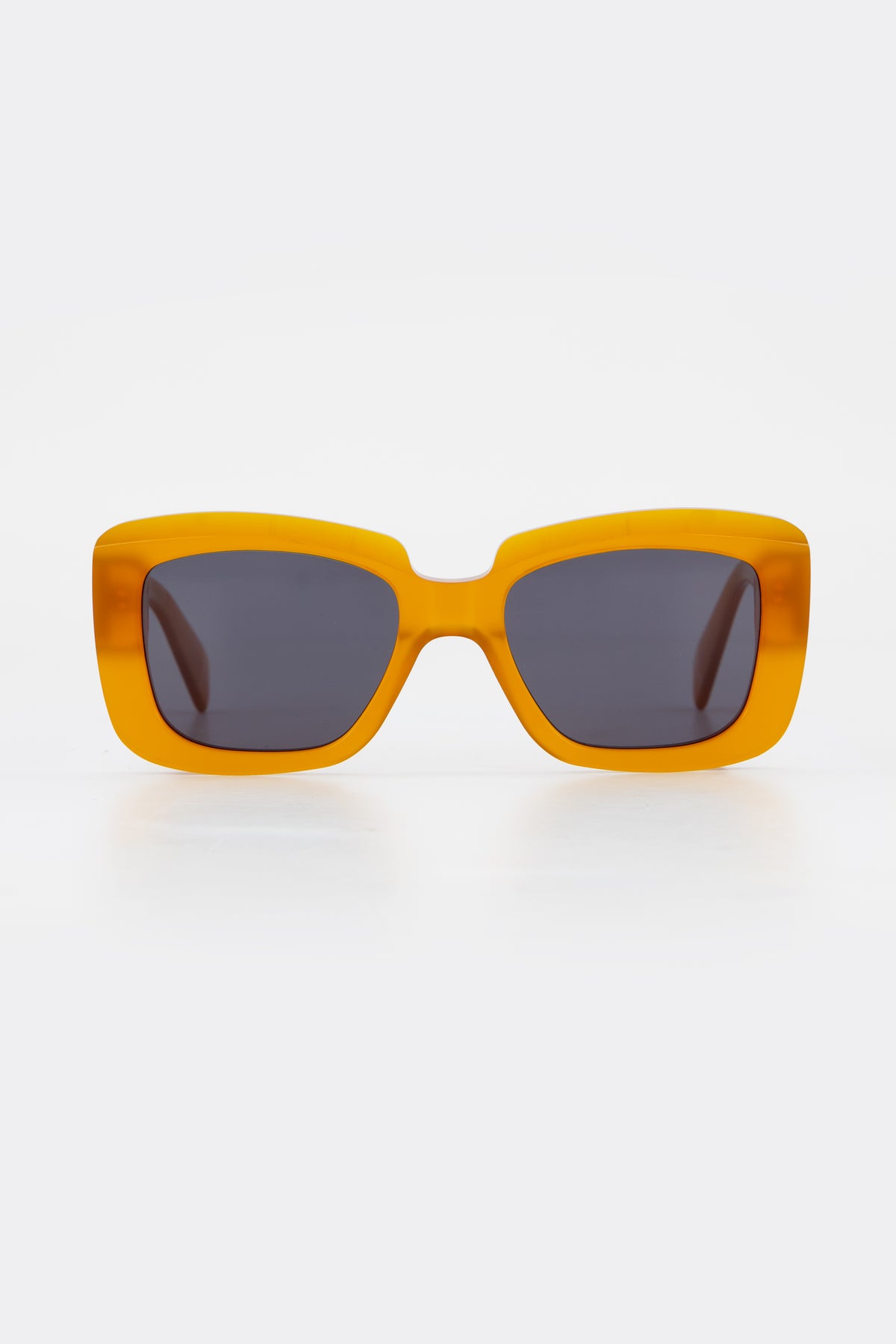 Isle of Eden Pia peach sunglasses, front view showing bold rectangular frame and dark lenses