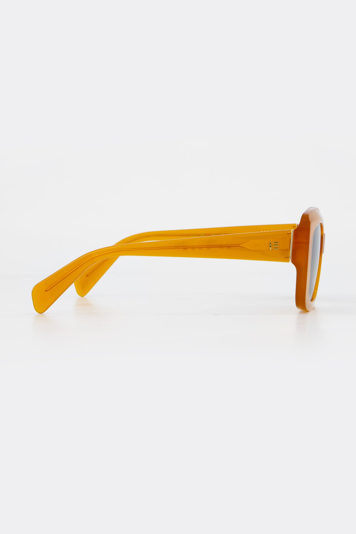 Isle of Eden Pia peach sunglasses, side profile view showing temple length and hinge detail