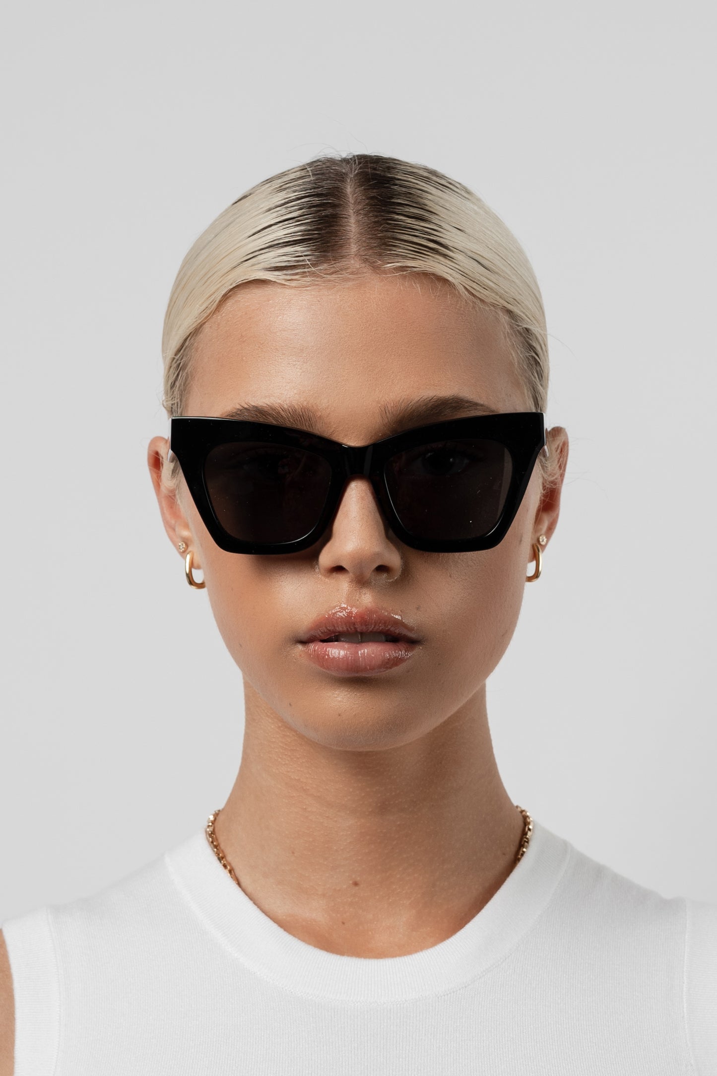 Woman wearing Isle of Eden Sienna black sunglasses, front-facing portrait looking directly at the camera