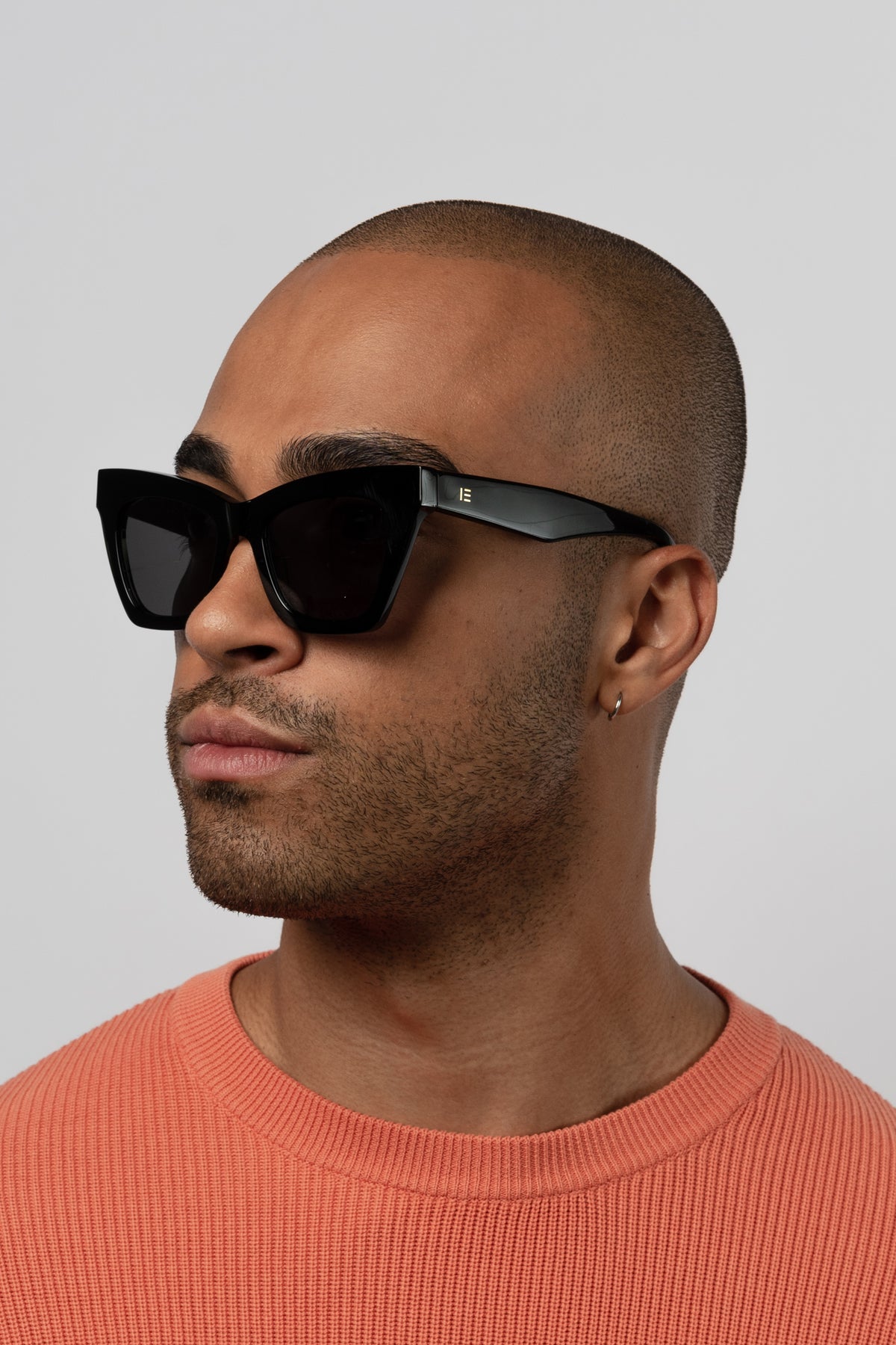 Man wearing Isle of Eden Sienna black sunglasses, angled portrait