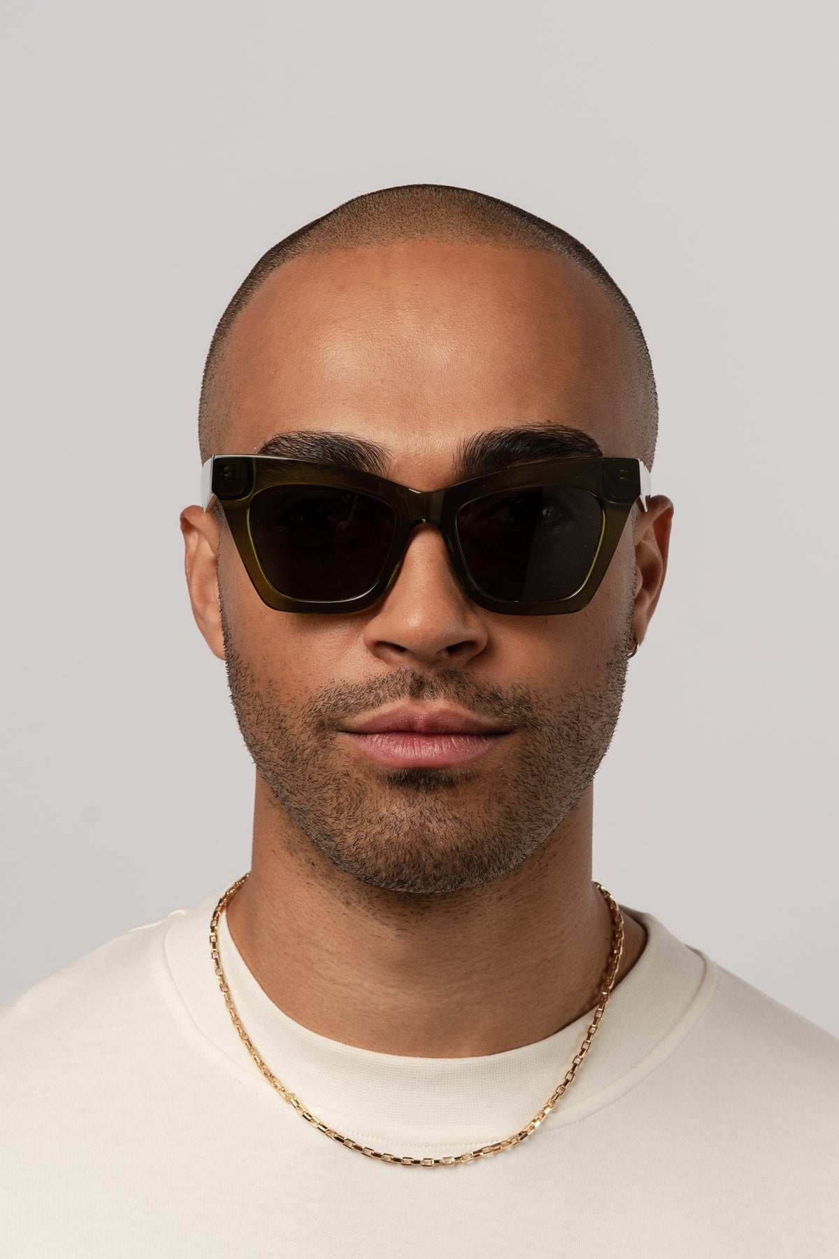 Man wearing Isle of Eden Sienna bottle green sunglasses, front-facing portrait