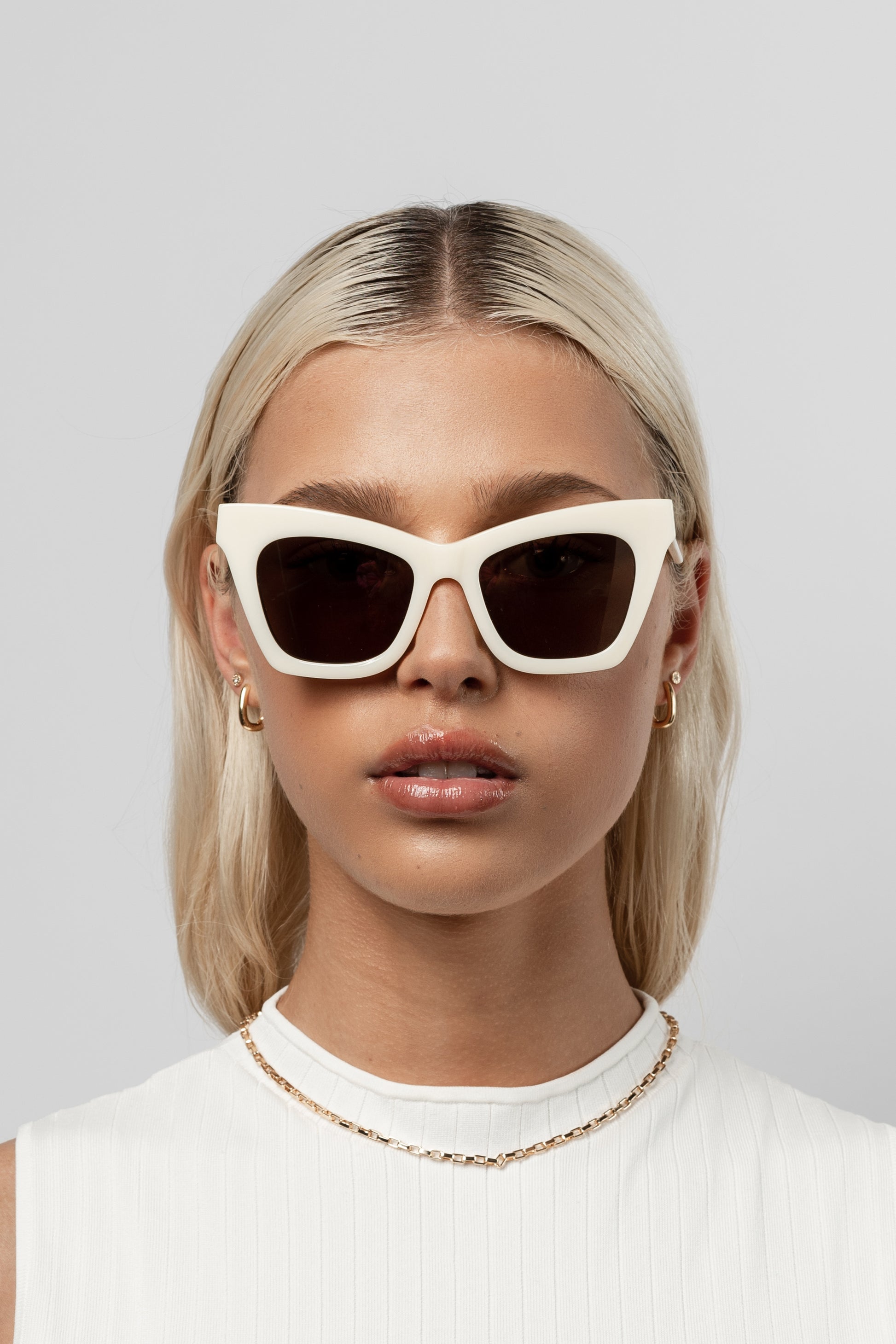 Woman wearing Isle of Eden Sienna ivory sunglasses, front-facing portrait looking directly at the camera