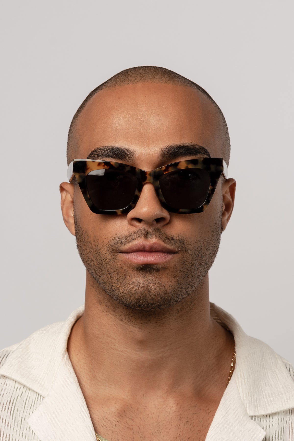 Man wearing Isle of Eden Sienna tortoise sunglasses, front-facing portrait