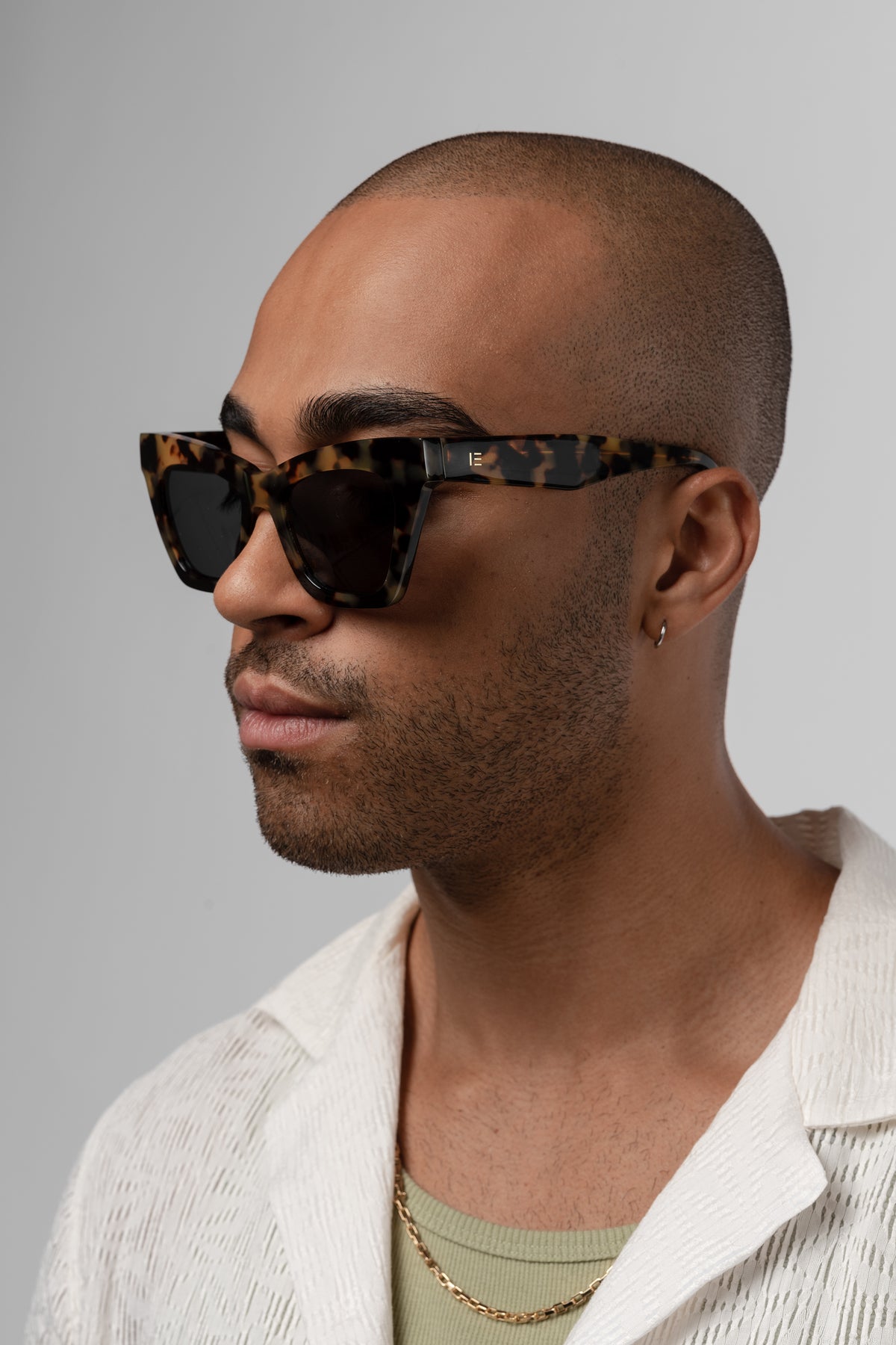 Man wearing Isle of Eden Sienna tortoise sunglasses, side profile portrait