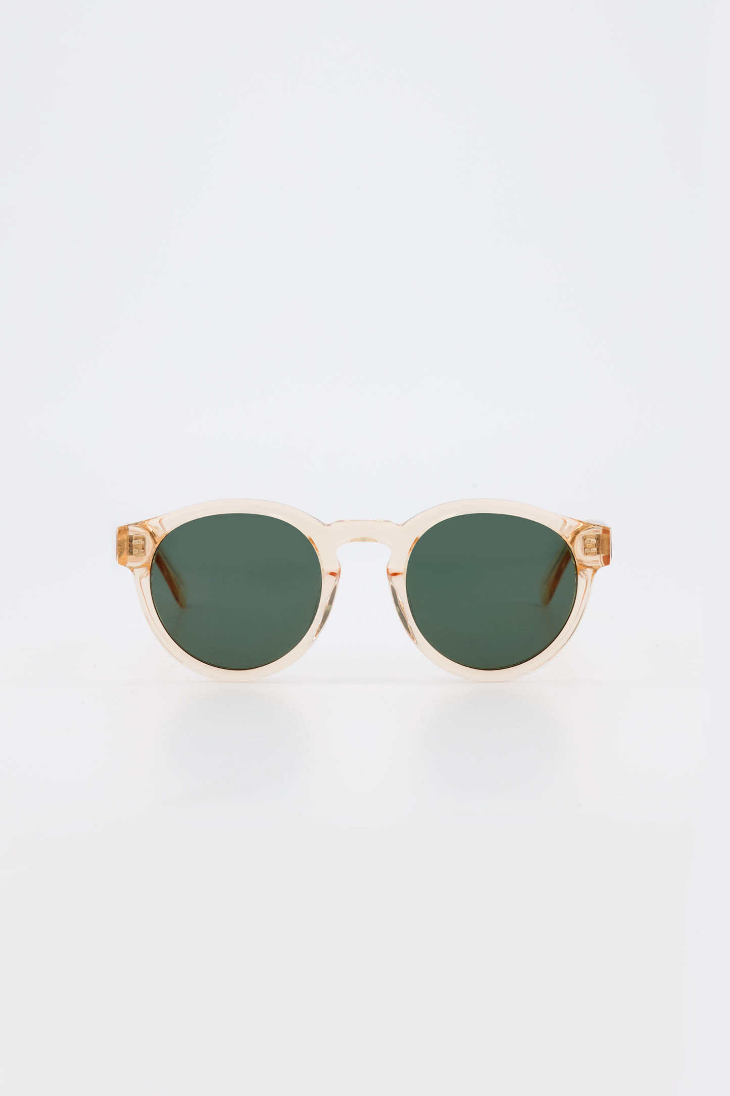 Isle of Eden Eddie champagne sunglasses, front view showing round frame and green lenses