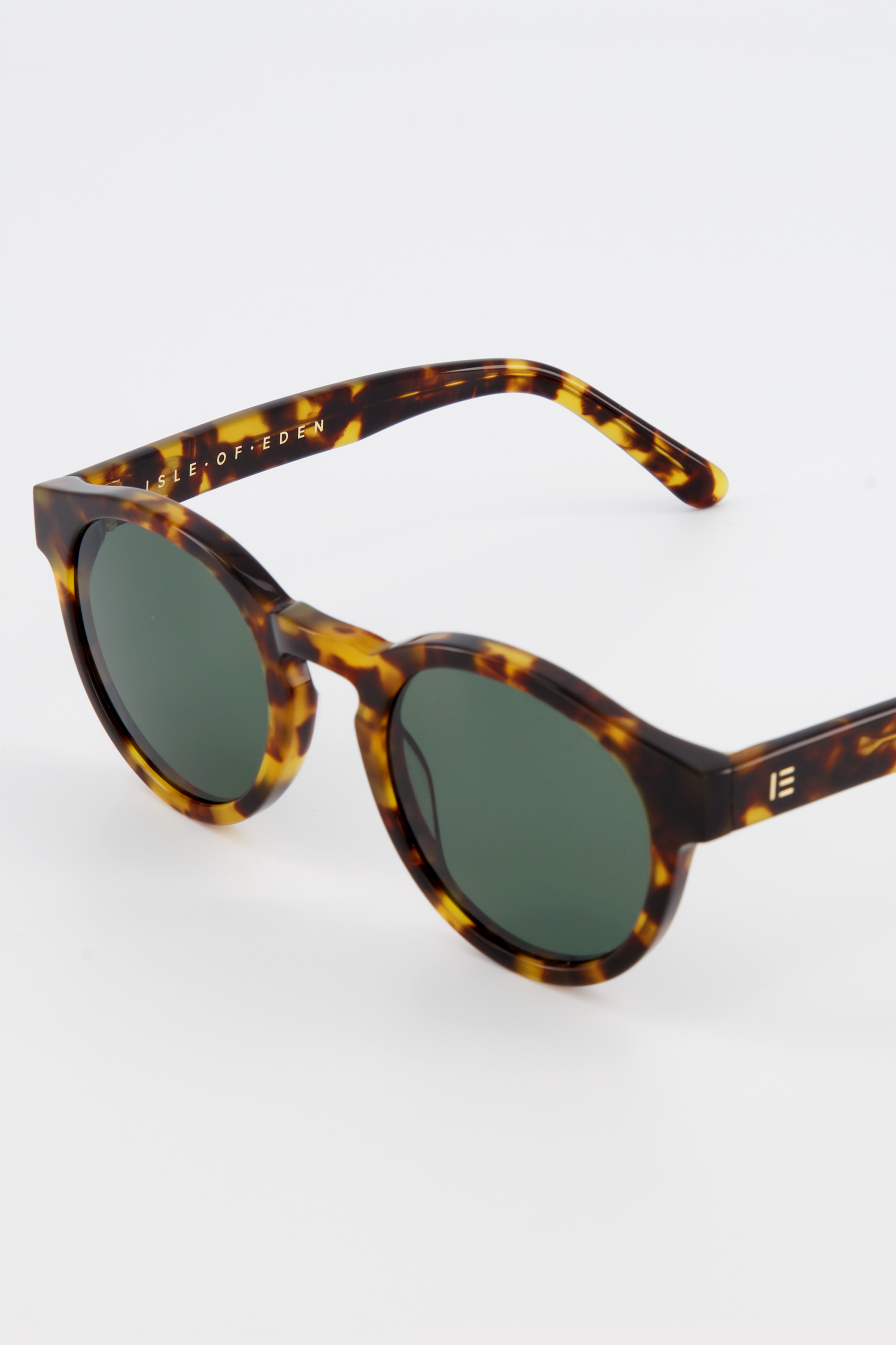 Close-up of Isle of Eden Eddie tortoise sunglasses showing round frame and brand lettering