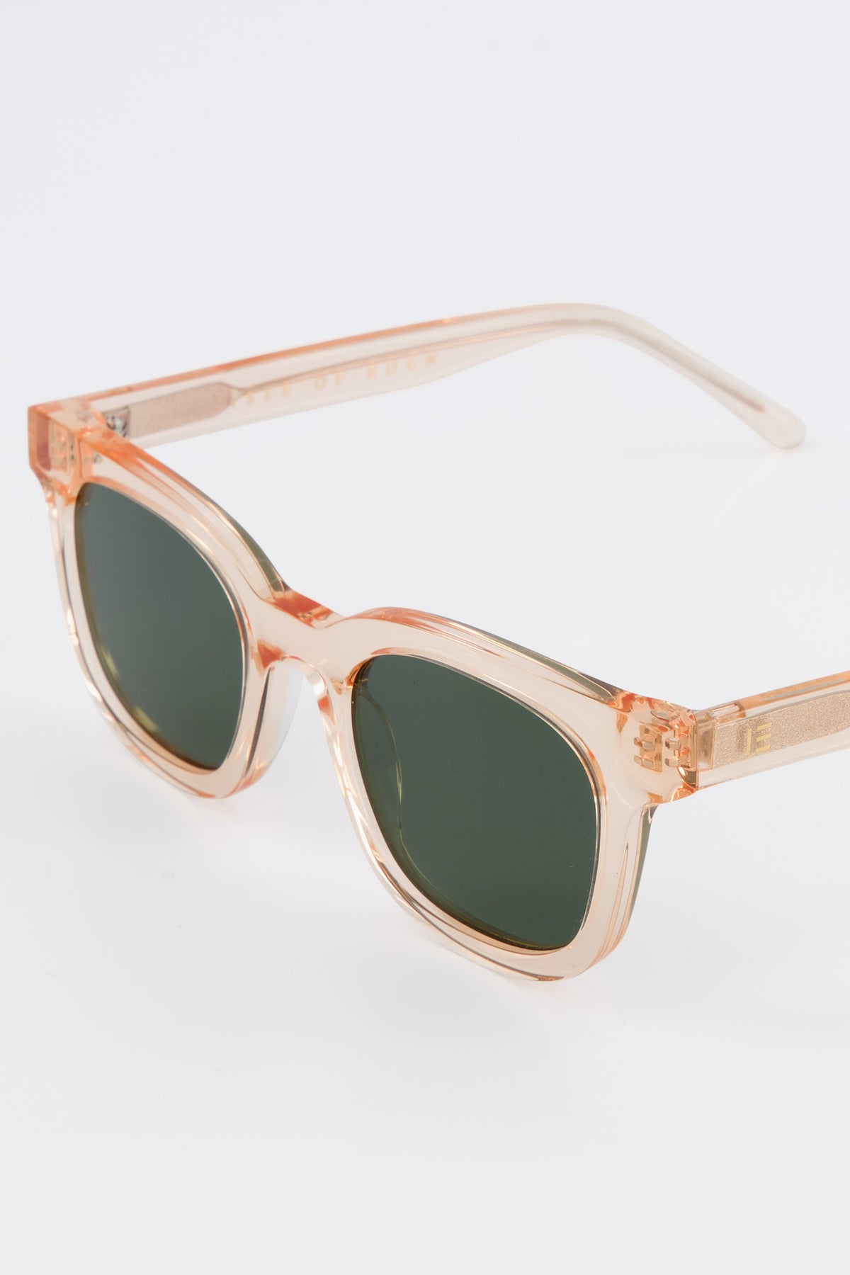 Close-up of Isle of Eden Eugene champagne sunglasses showing flat brow frame and brand lettering