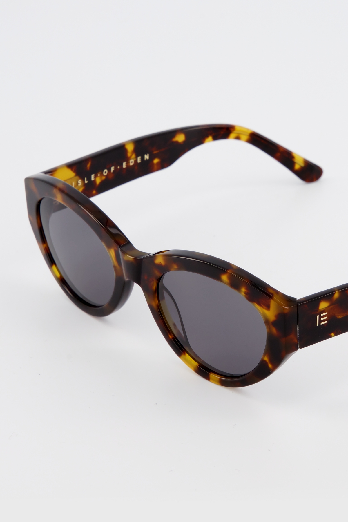 Close-up of Isle of Eden Felina tortoise sunglasses showing cat-eye frame and brand lettering