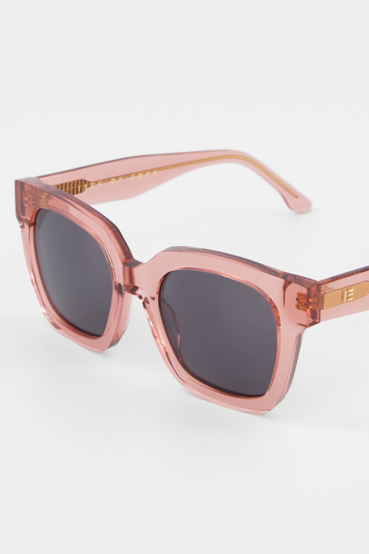 Close-up of Isle of Eden Maleika rosewood sunglasses showing oversized frame and brand lettering