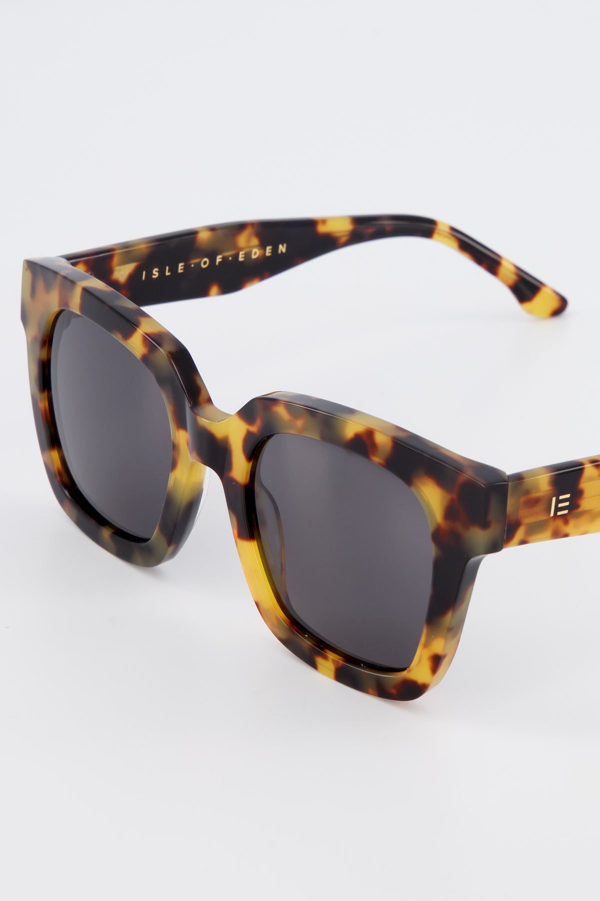 Close-up of Isle of Eden Maleika tortoise sunglasses showing oversized frame and brand lettering