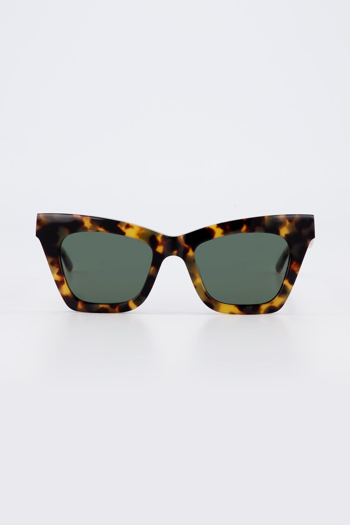 Isle of Eden Sienna tortoise sunglasses, front view showing angular cat-eye frame and green lenses