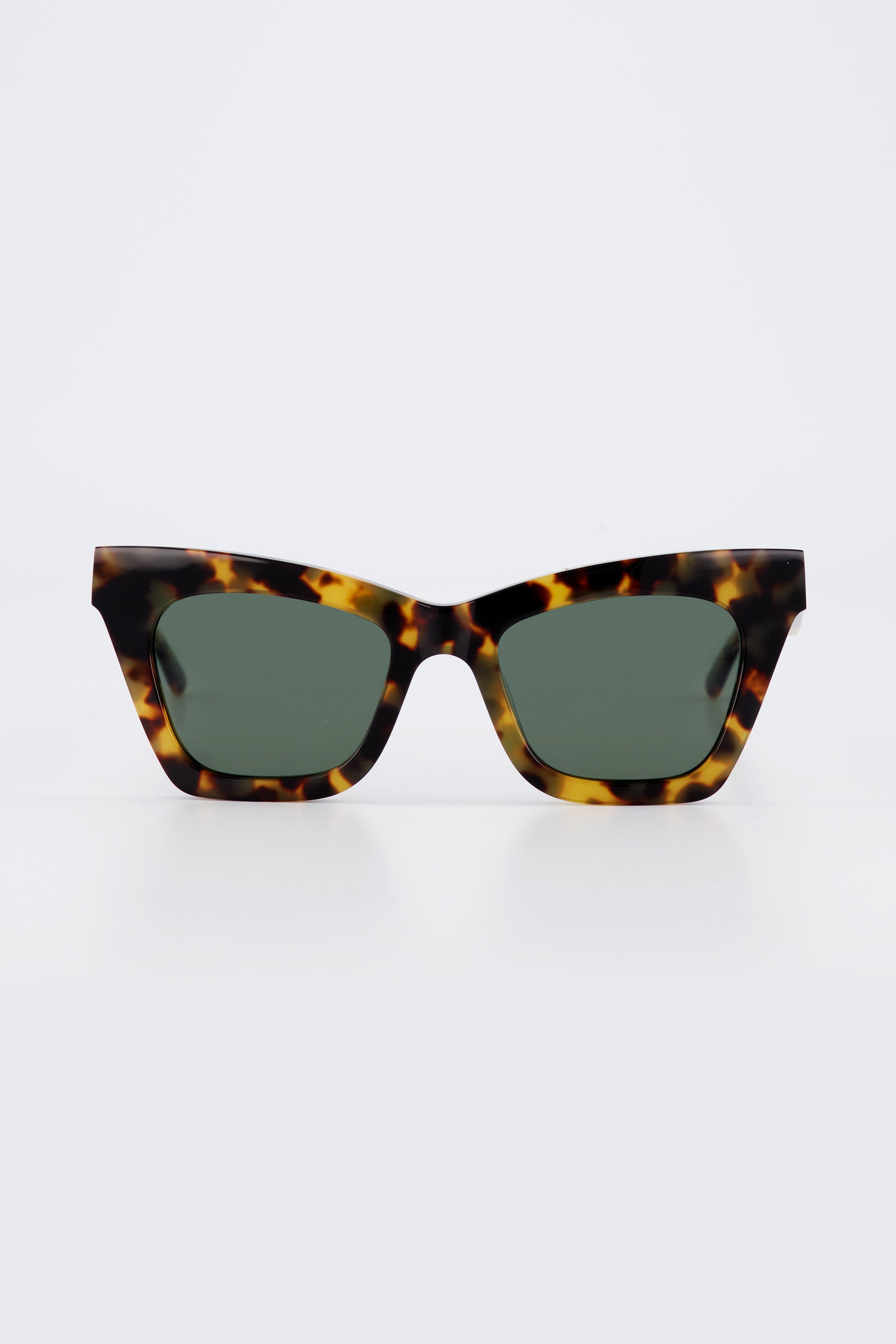 Isle of Eden Sienna tortoise sunglasses, front view showing angular cat-eye frame and green lenses