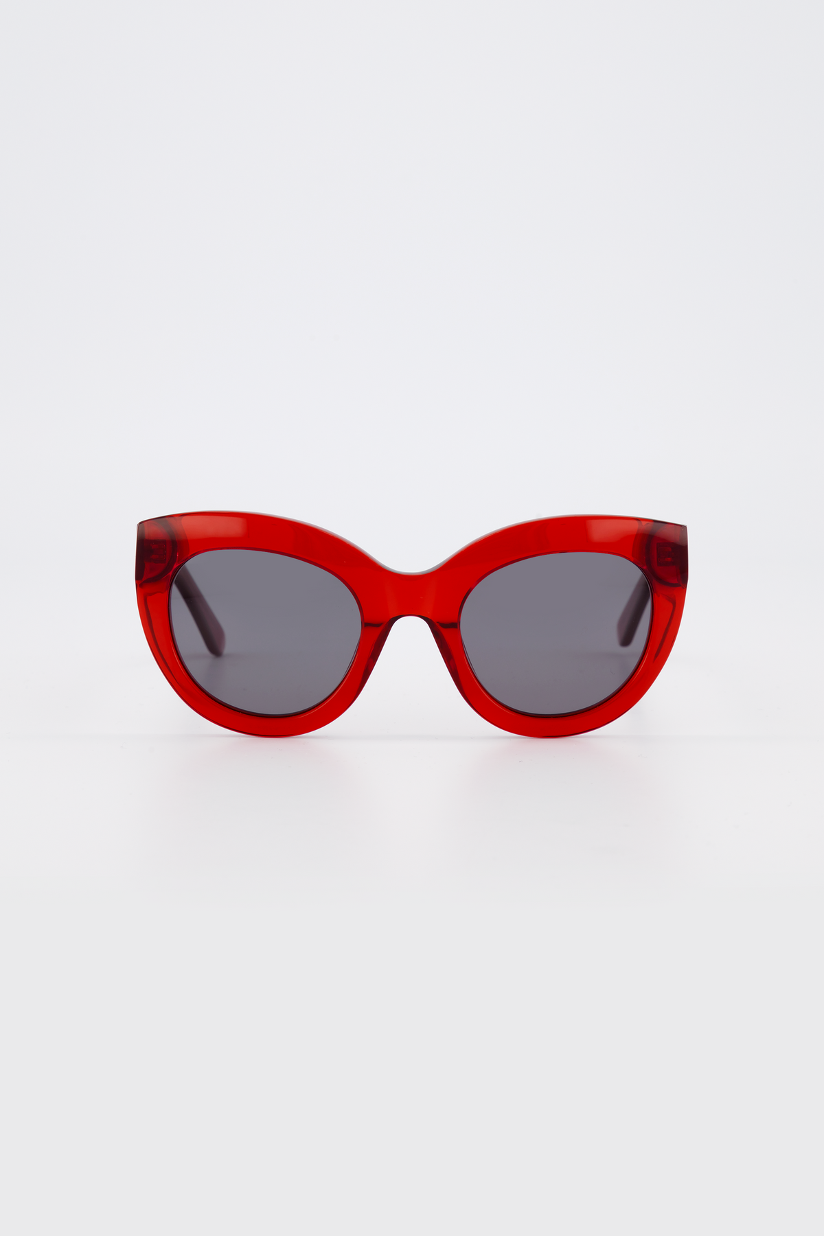 Isle of Eden Wynnie red sunglasses, front view showing oversized cat-eye frame and grey lenses